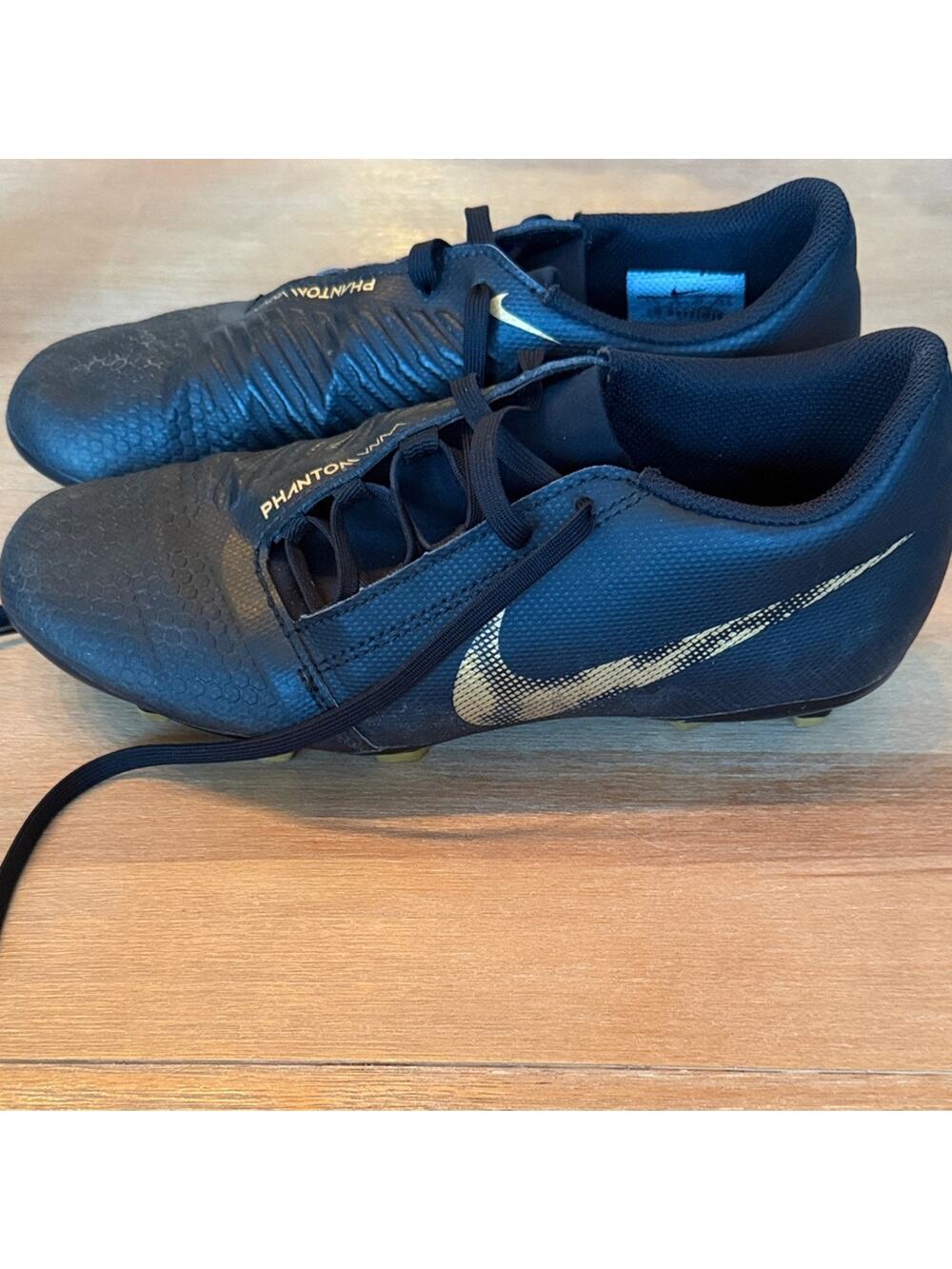 Nike Phantom Venom Club FG Black and Vivid Metallic Gold Cleats.